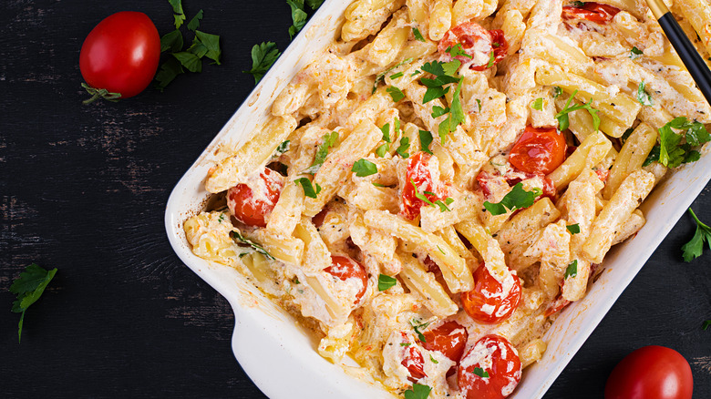 Baked goat cheese and tomato pasta in casserole