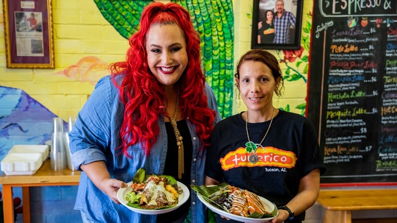 Claudia Sandoval holding enchiladas and tamales