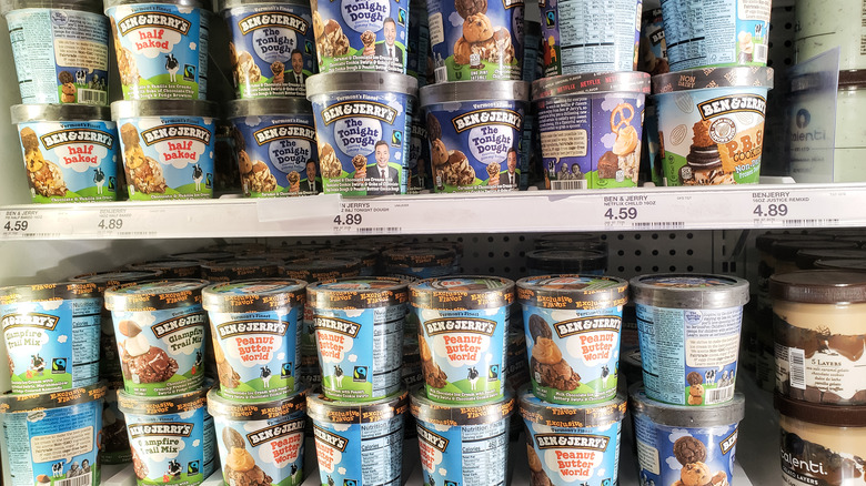 Several cartons of Ben and Jerry's in a grocery store freezer