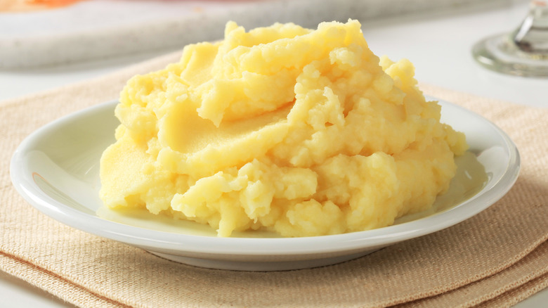 Yellow mashed potatoes on white plate