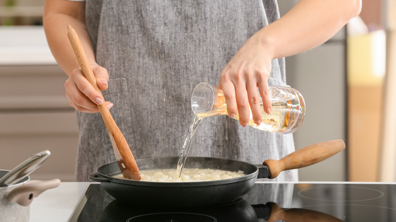 Woman cooking risotto 