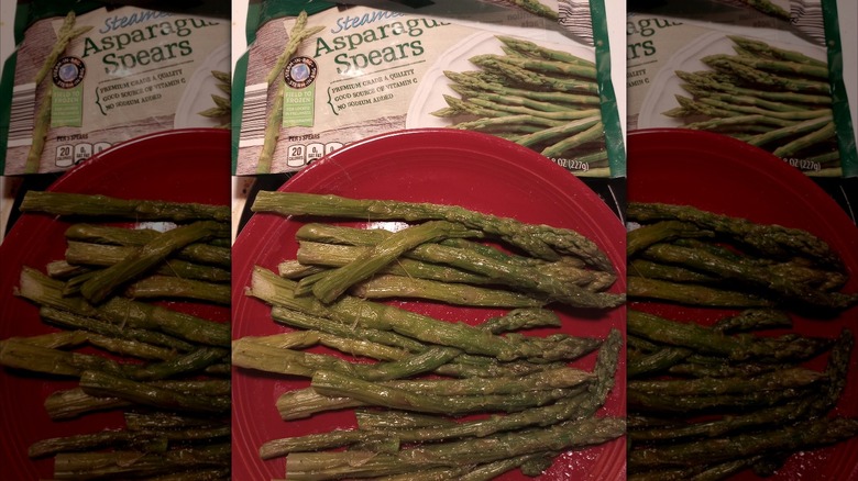 Wilted asparagus on red plate