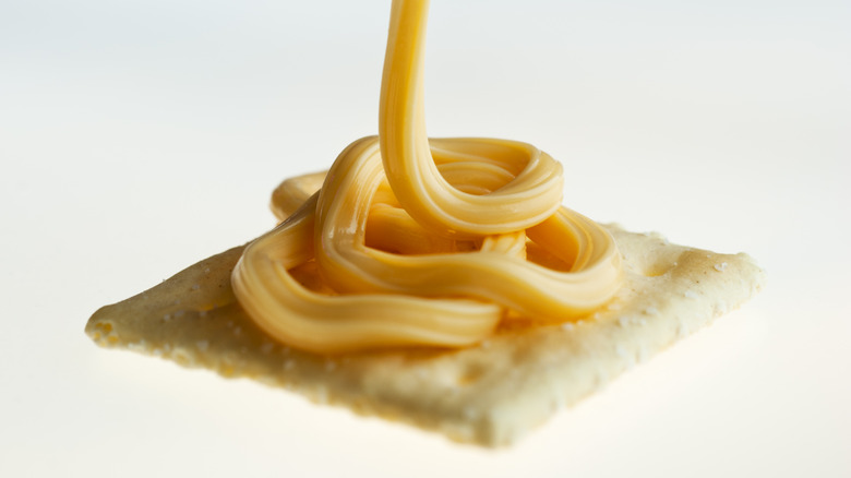 spray cheese on cracker