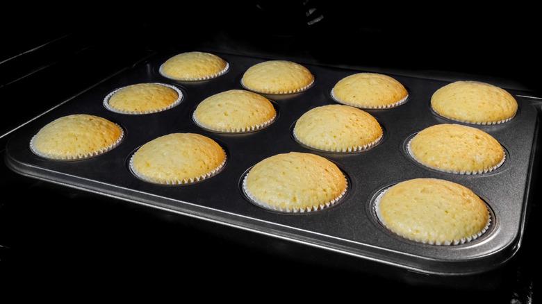 fresh undecorated cupcakes in oven