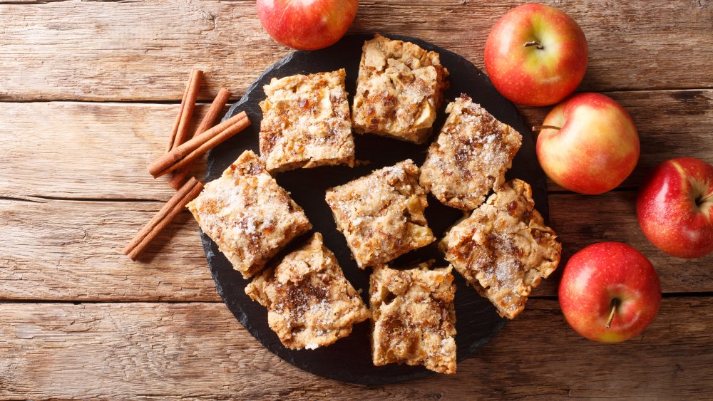 plate of blondies with cinnamon sticks and apples