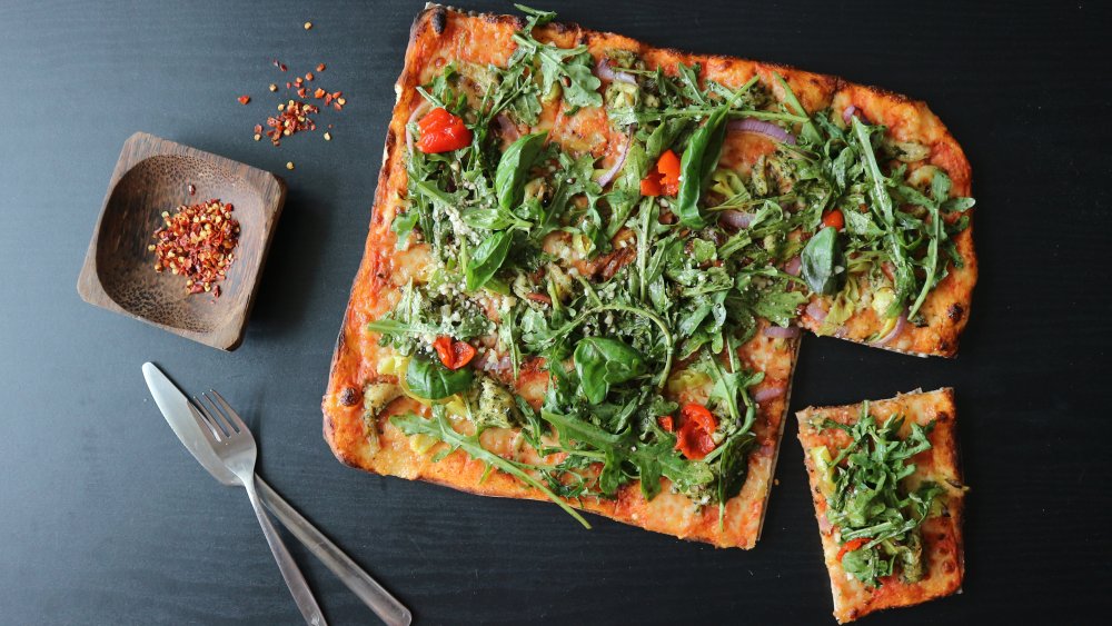 Pizza with cherry tomatoes and arugula 