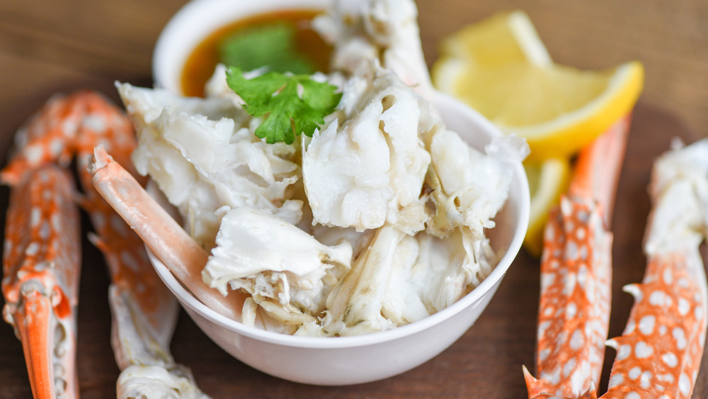 crab meat in bowl and crab legs