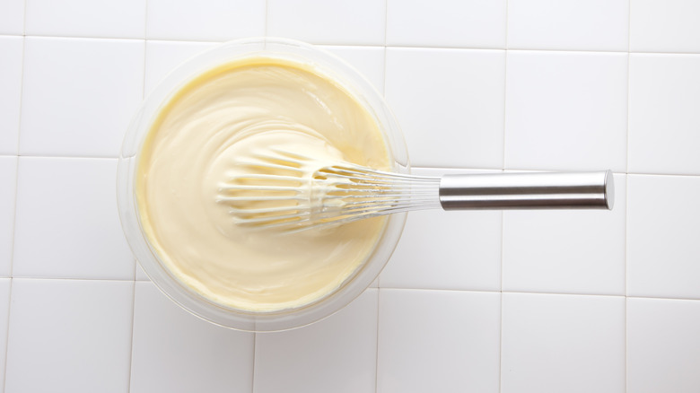 bowl of homemade mayonnaise with whisk