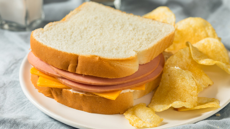 Bologna sandwich with cheese and potato chips