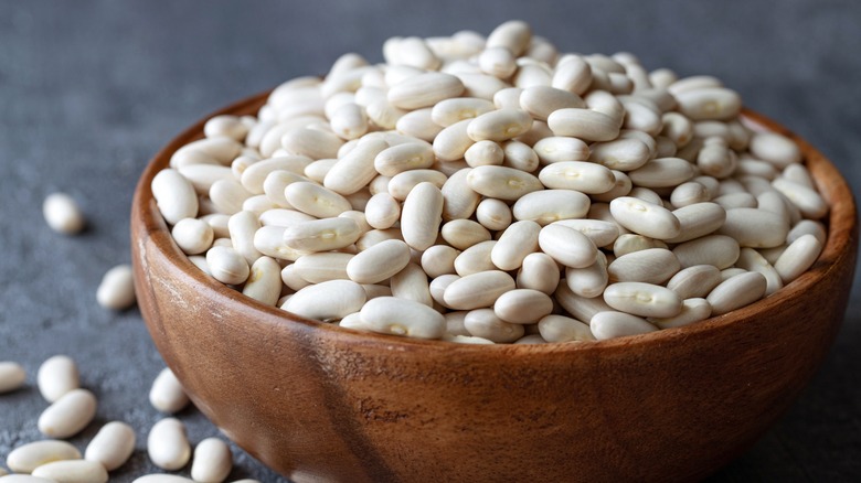 dry white beans in a brown bowl