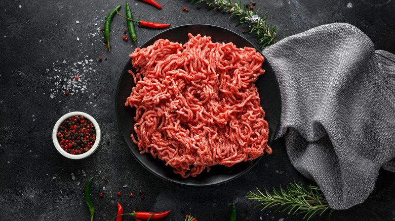 Overhead shot of raw ground beef on black plate