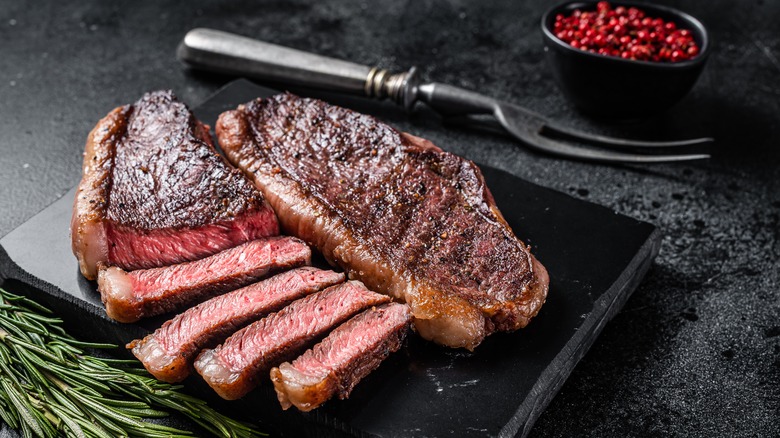 Rare steak on black slate board