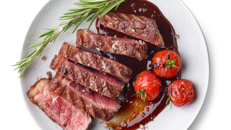 Thick slices of raw steak on a white plate