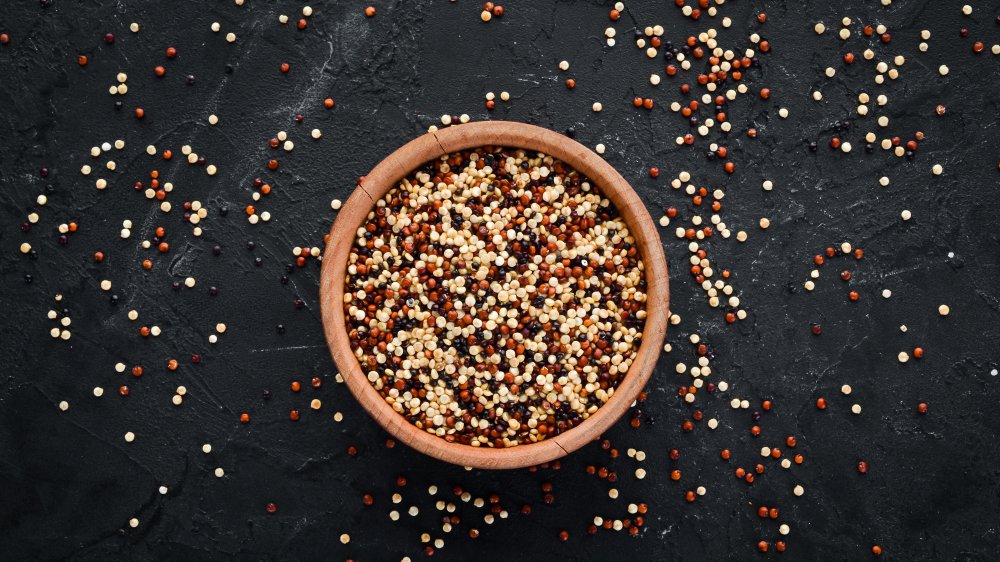 bowl of mixed quinoa on a black background