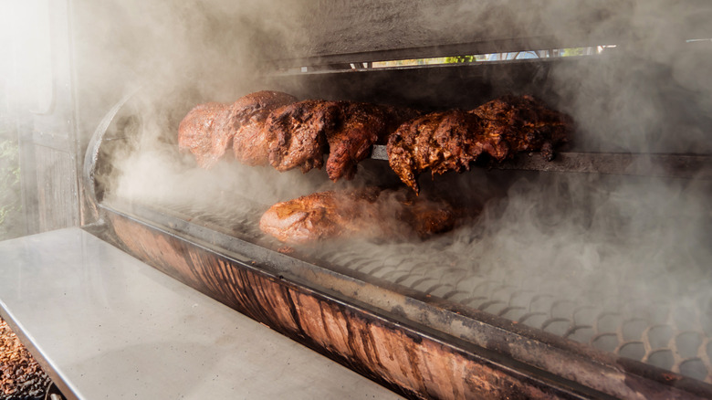 Cooked meat rotating in a smoker