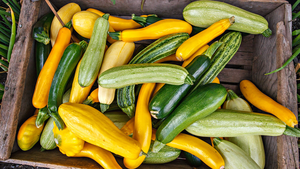 A wooden box full of summer squash