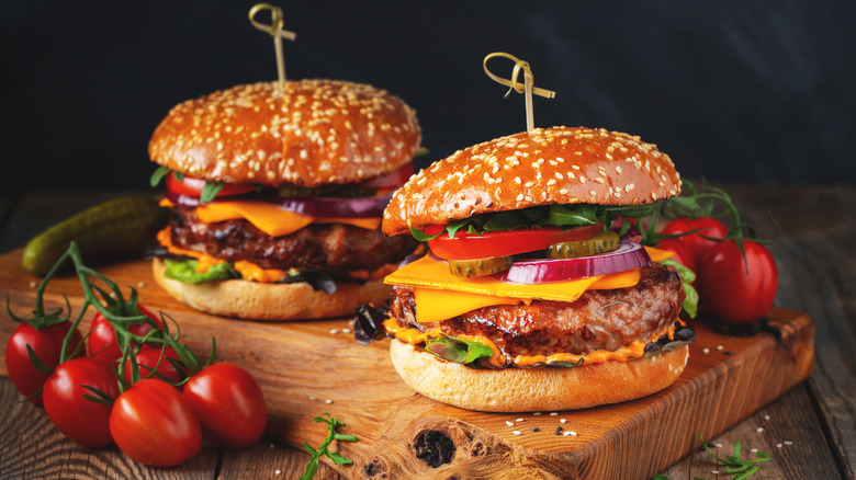 Two hamburgers on a board