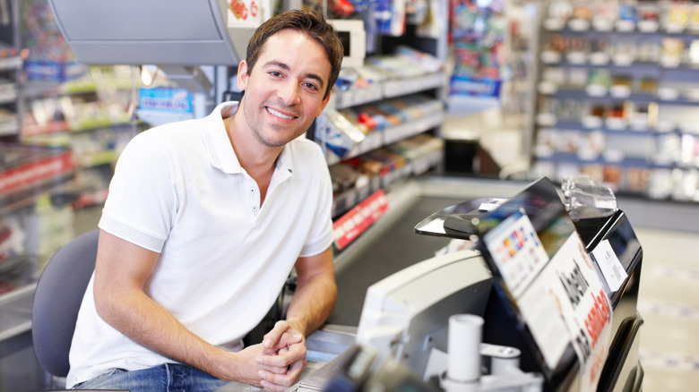 seated cashier smiling