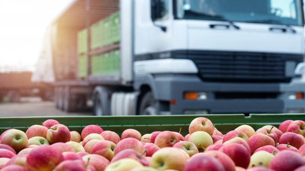 truck behind loads of apples
