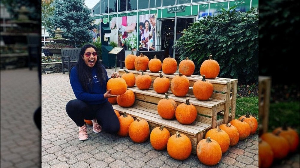 TV personality Natasha de Bourg holding a pumpkin