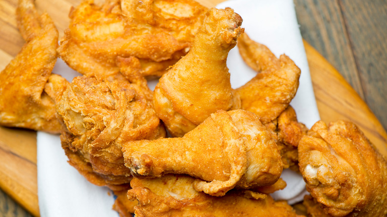 fried chicken on wood plank