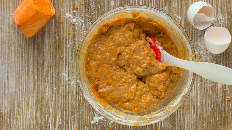 Carrot cake batter in a bowl with spatula