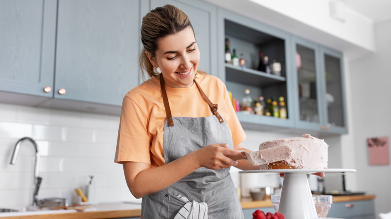 Woman frosting cake a thome