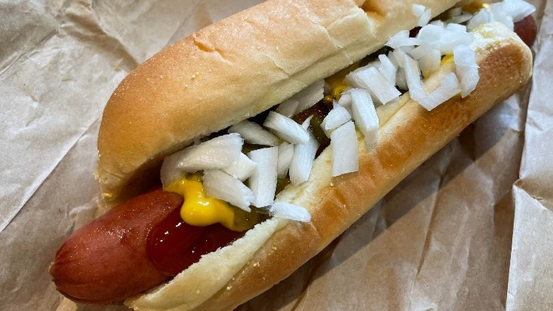 Costco hot dog with ketchup, mustard, and onion