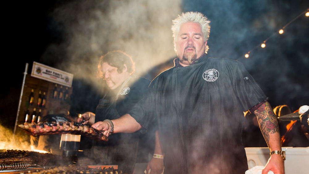 Guy Fieri cooking at a grill