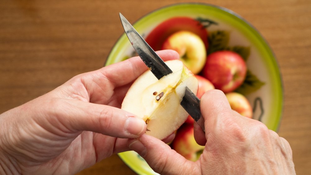 Woman cutting honeycrisp apple