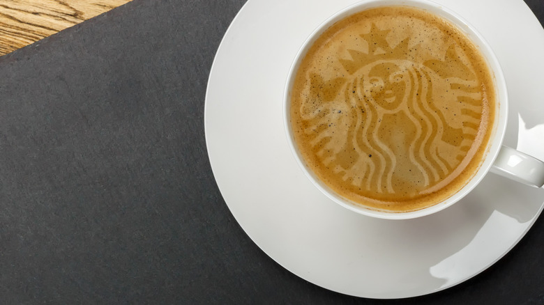 A coffee with the Starbucks logo in the foam, from above