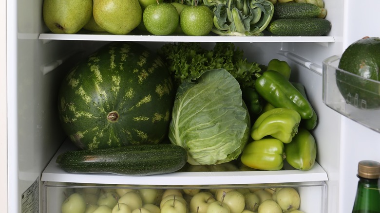 Fridge with green fruits and vegetables