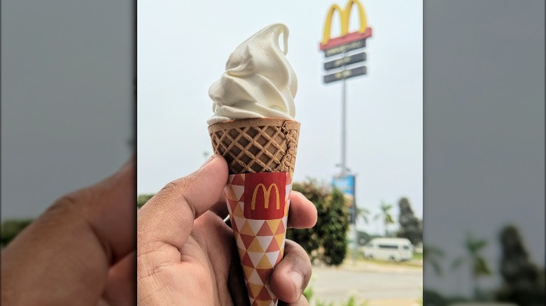 McDonald's soft serve cone in front of golden arches