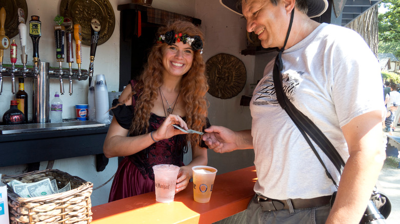 Renaissance festival woman selling drinks