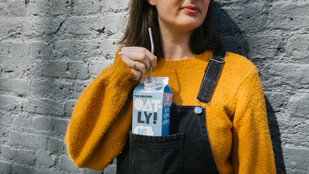 Oatly drinker wearing overalls