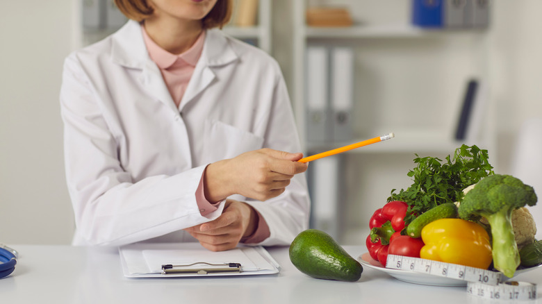 nutritionist or doctor in front of vegetables