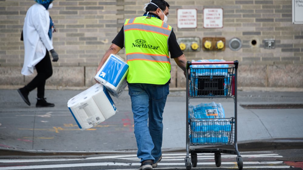 shopper transporting large quantities of paper towels and bottled water