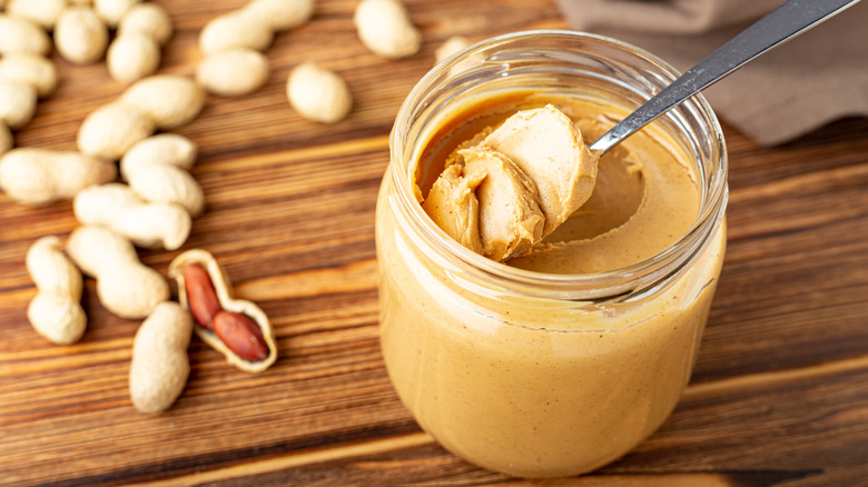 Spoon of peanut butter in jar