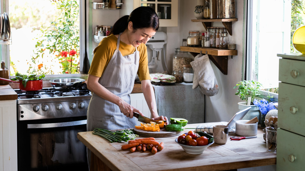 Woman cooking with online instruction