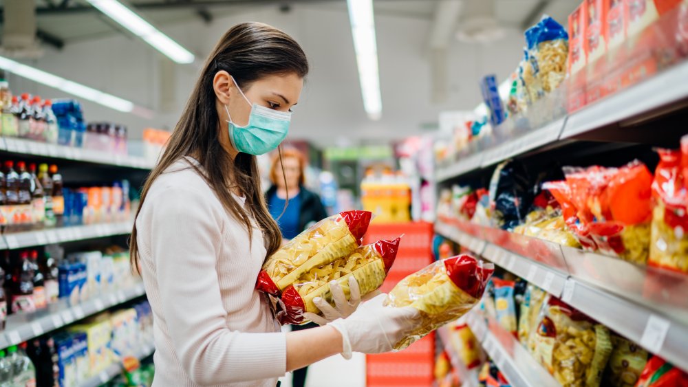 A woman interrogating her decision to buy pasta from a supermarket during the age of coronavirus. Linguini or not linguini, that is the question.