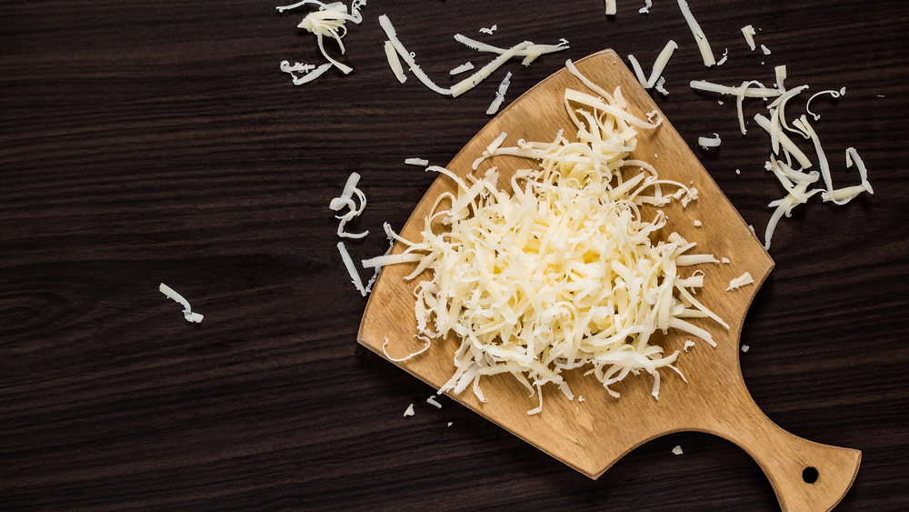 Grated cheese on cutting board