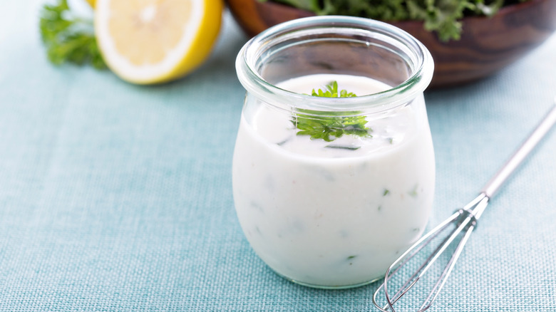 container of ranch dressing and whisk