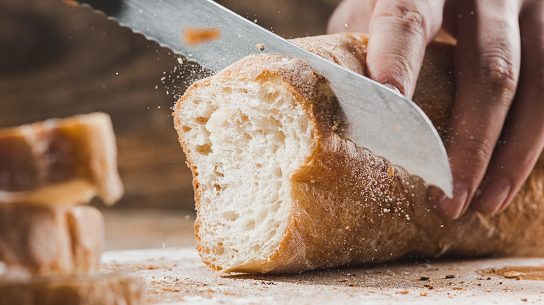 Kitchen chef cutting bread