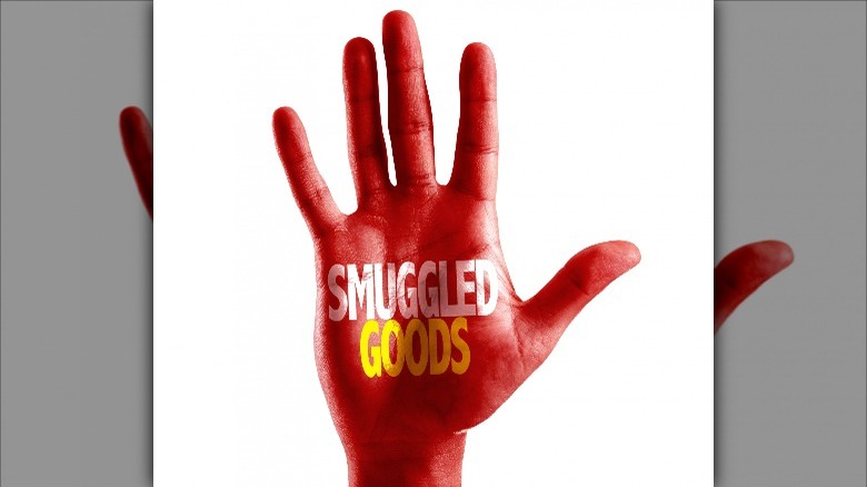 red hand reading smuggled goods