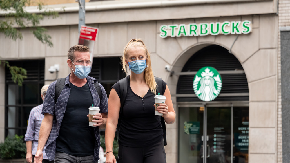 Starbucks customers with store in the background