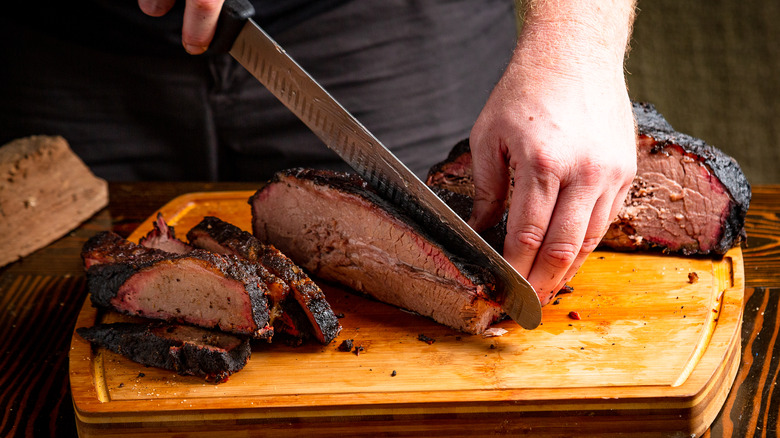 Steak being cut with butcher knife