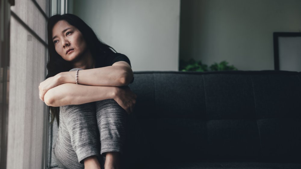 depressed woman in window