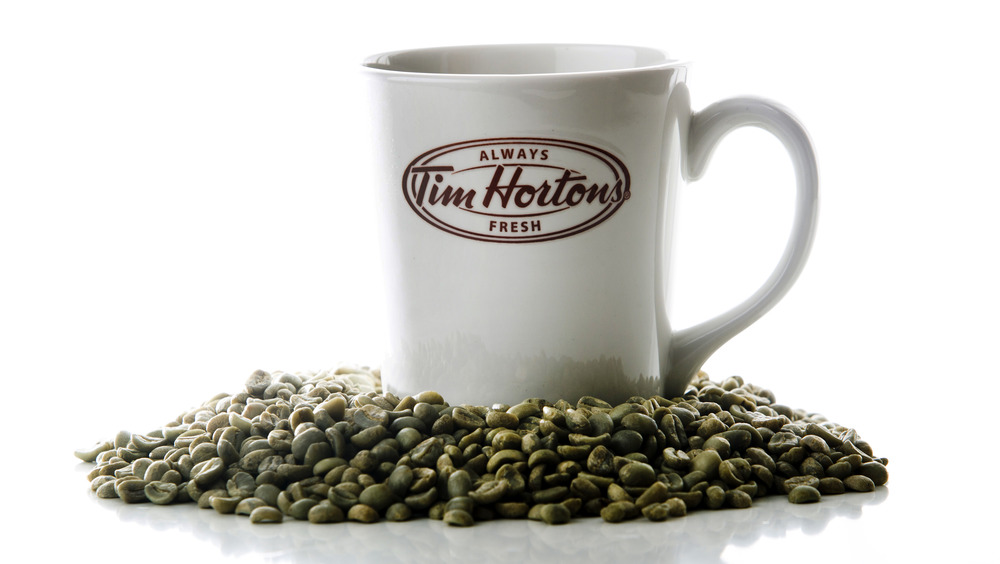 Tim Hortons mug amid coffee beans