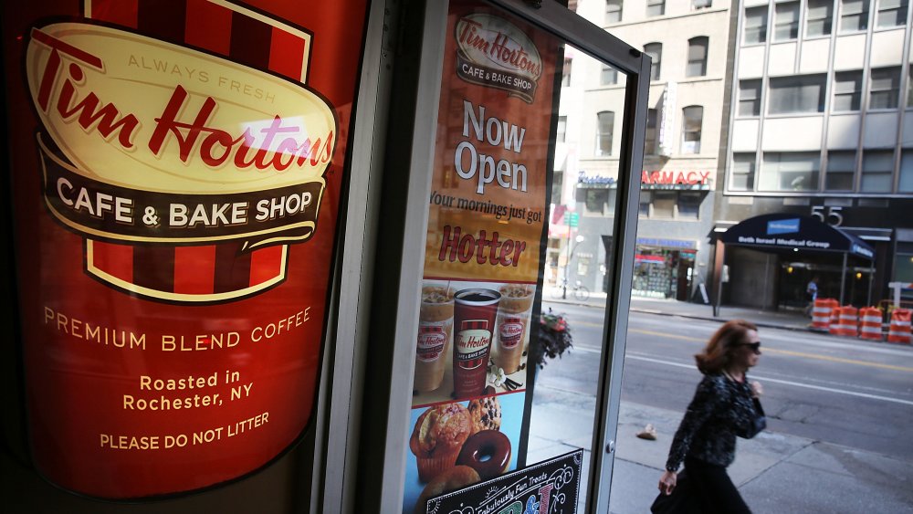 Woman walking past Tim Hortons