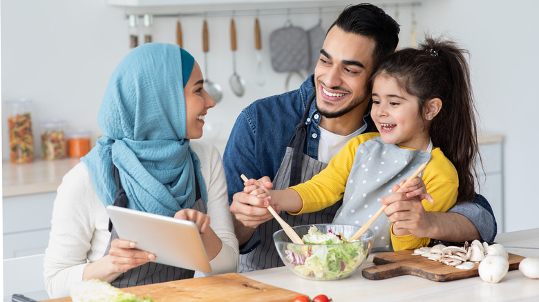 family happily cooking together